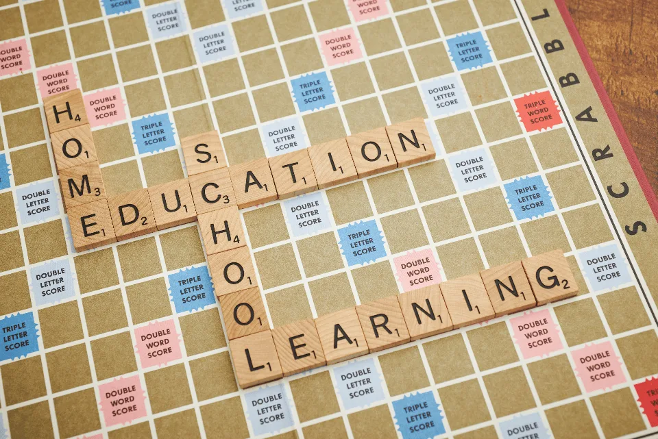 Educational games: wooden letter tiles spelling education and learning on a game board