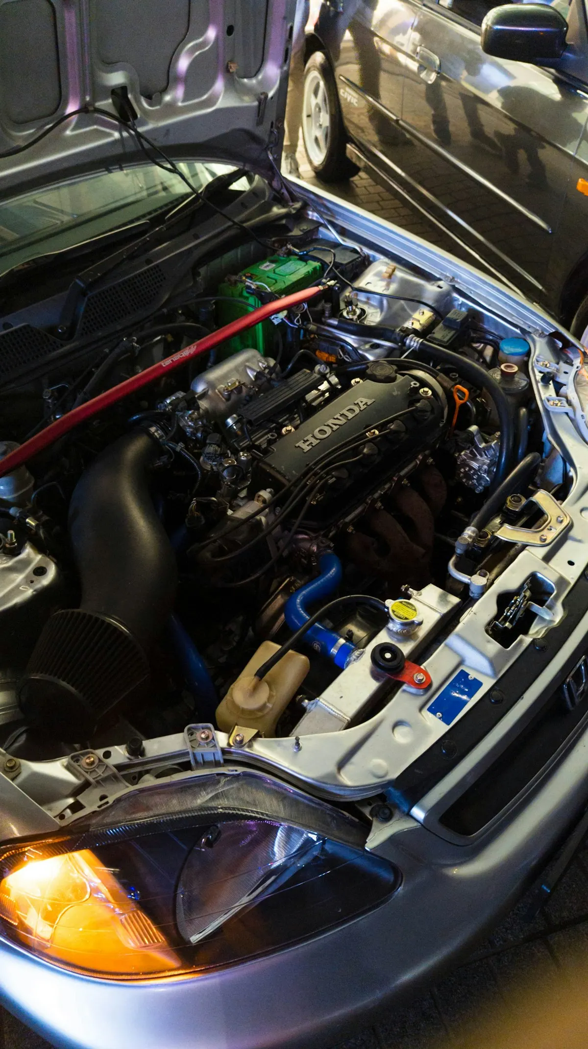 Car engine bay where misfires and worn mounts can cause shaking