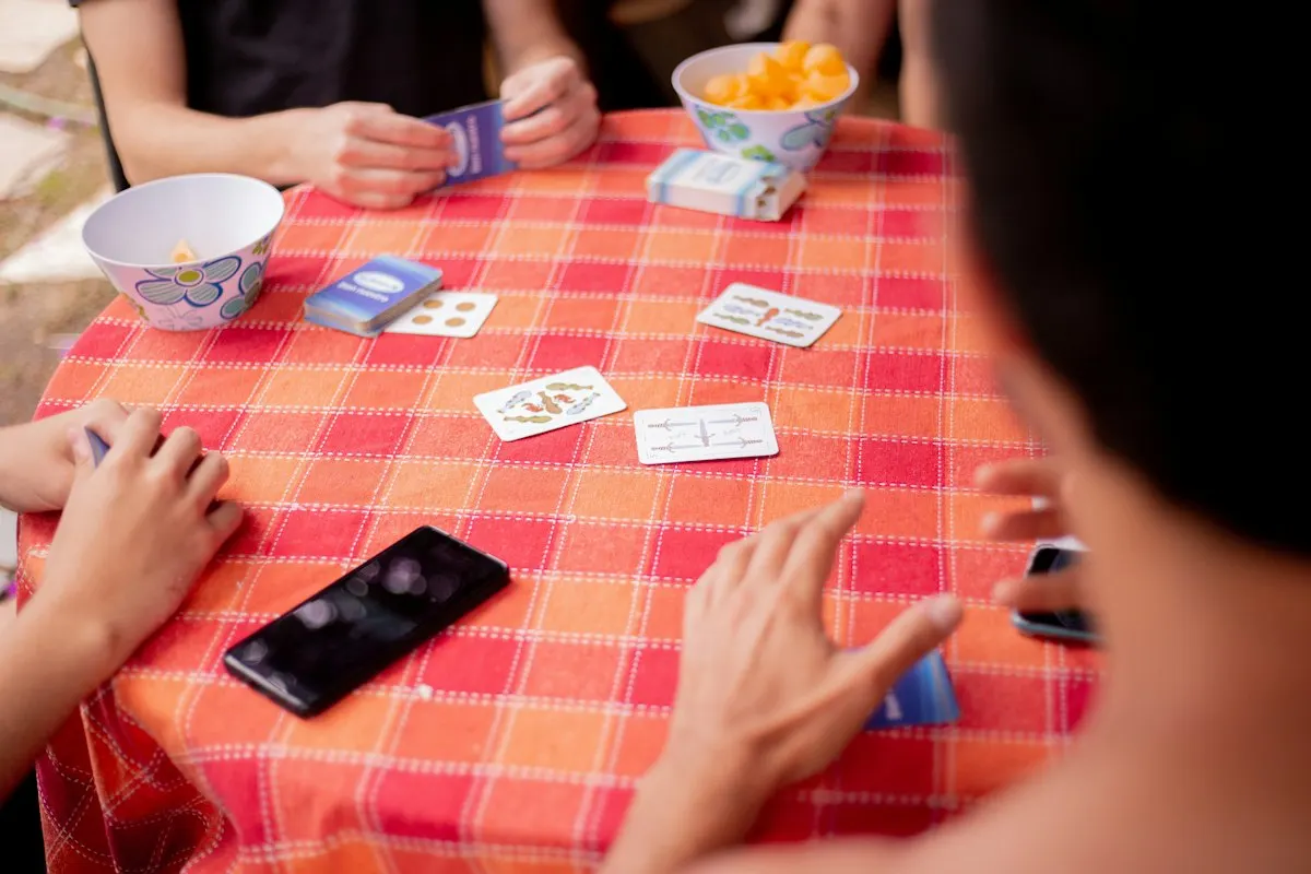 Friends playing a card game around a table using Rummy 500 strategy