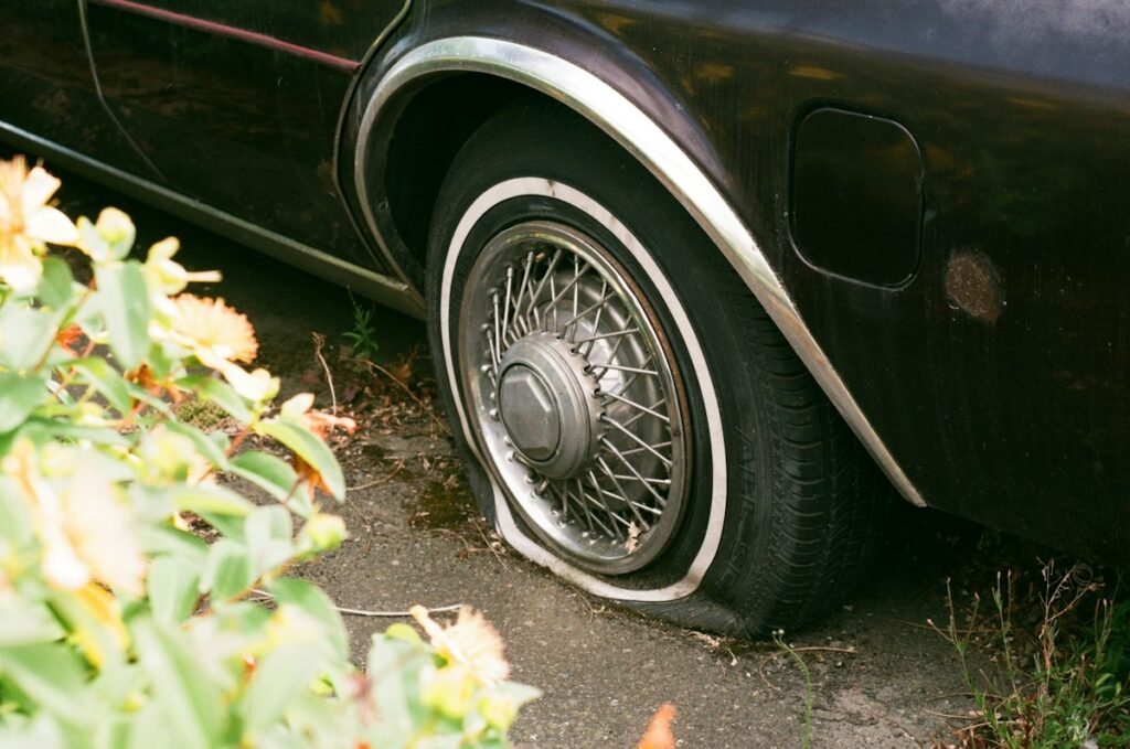 How Long Can You Drive on a Spare Tire? Safe Miles and Speed Limits 2 Flat car tire that needs to be replaced with a spare