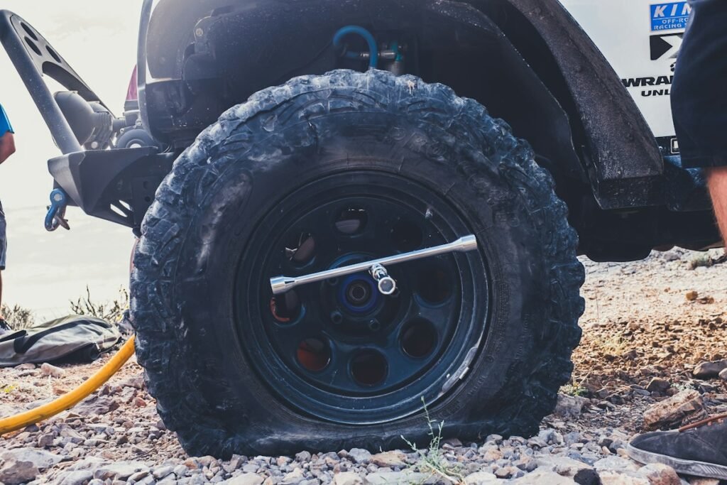 How Long Can You Drive on a Spare Tire? Safe Miles and Speed Limits 4 Close-up of a flat tire on the road