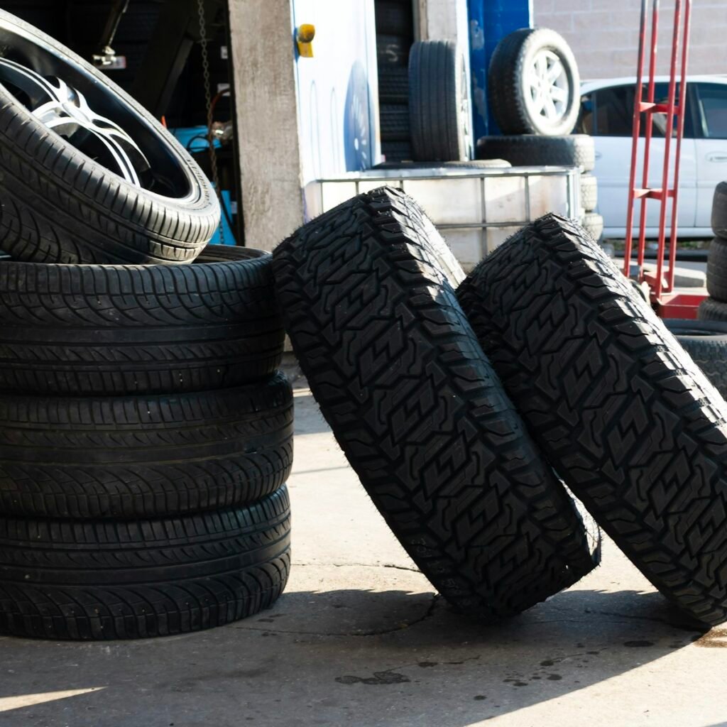 How Long Can You Drive on a Spare Tire? Safe Miles and Speed Limits 5 Stack of new tires outside an auto repair garage