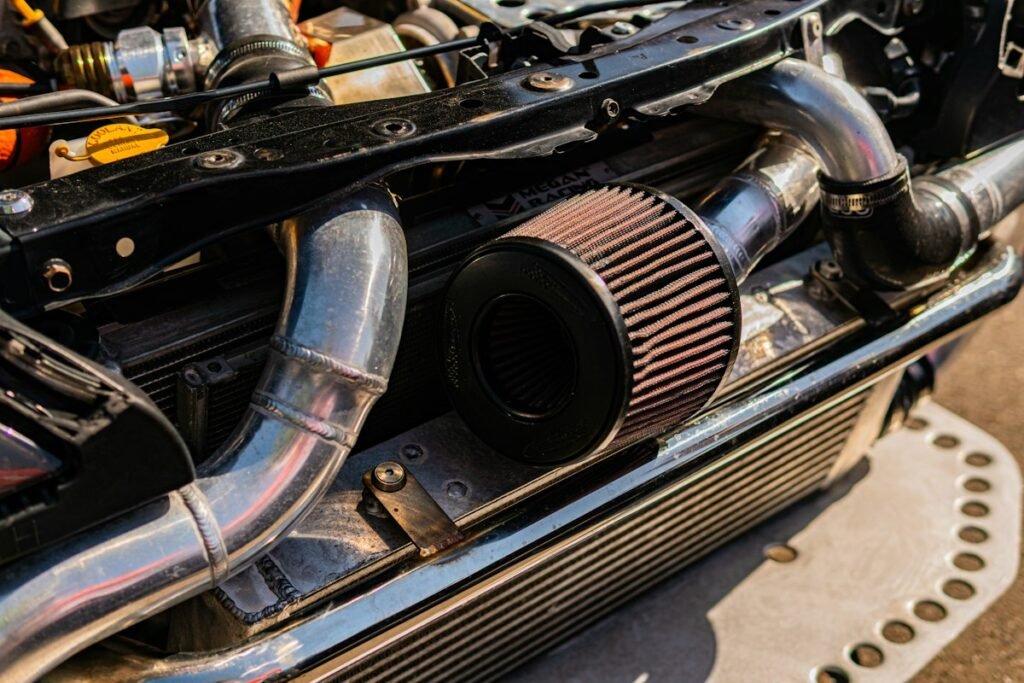 How to Change a Car Air Filter: Easy 10-Minute DIY Guide (With Photos) 4 Car engine bay with the air filter connected to the intake pipe