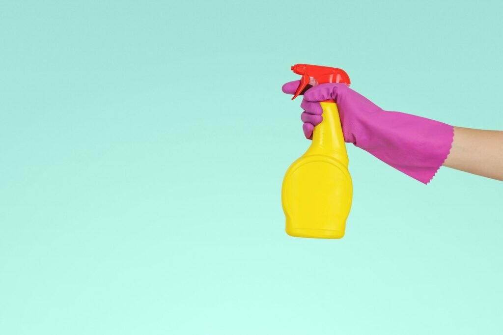 How to Clean Window Screens: 4 Easy Methods (With or Without Removing) 2 Person holding a spray bottle used for cleaning window screens