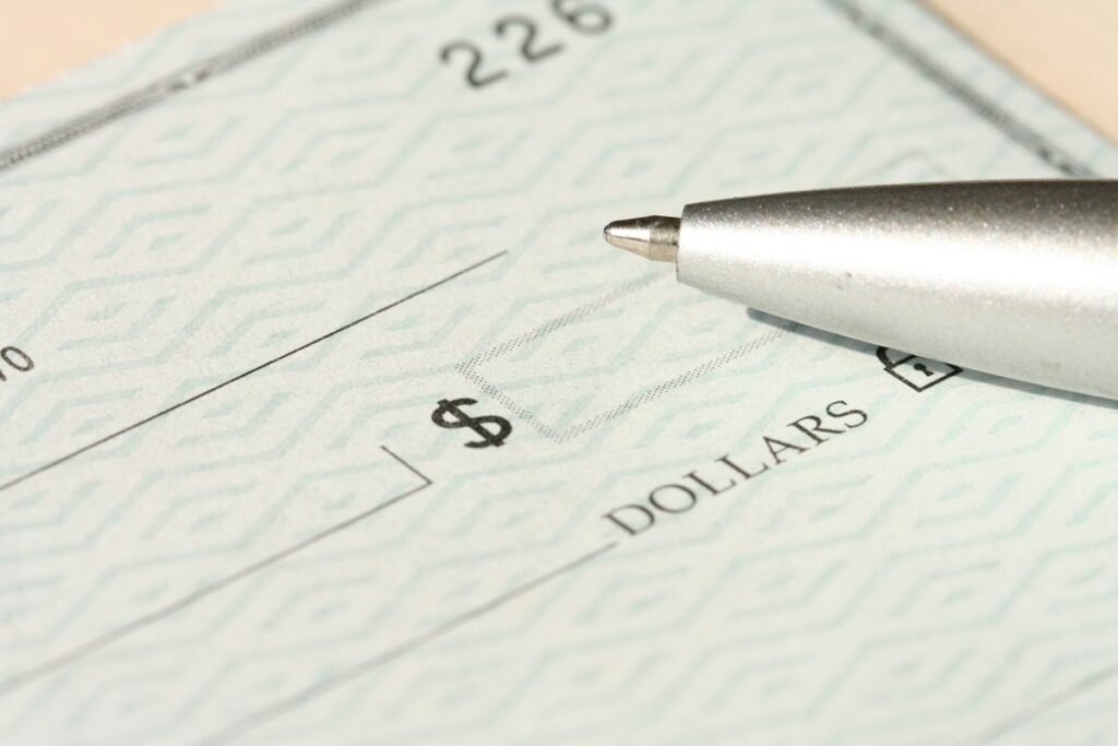 How to Fill Out a Money Order: Step-by-Step Guide (With Examples) 2 Pen resting on a payment form next to the dollar amount line