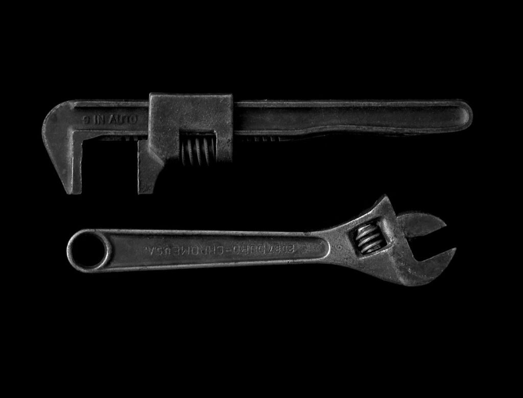 Adjustable wrench and pipe wrench used to fix a leaky faucet