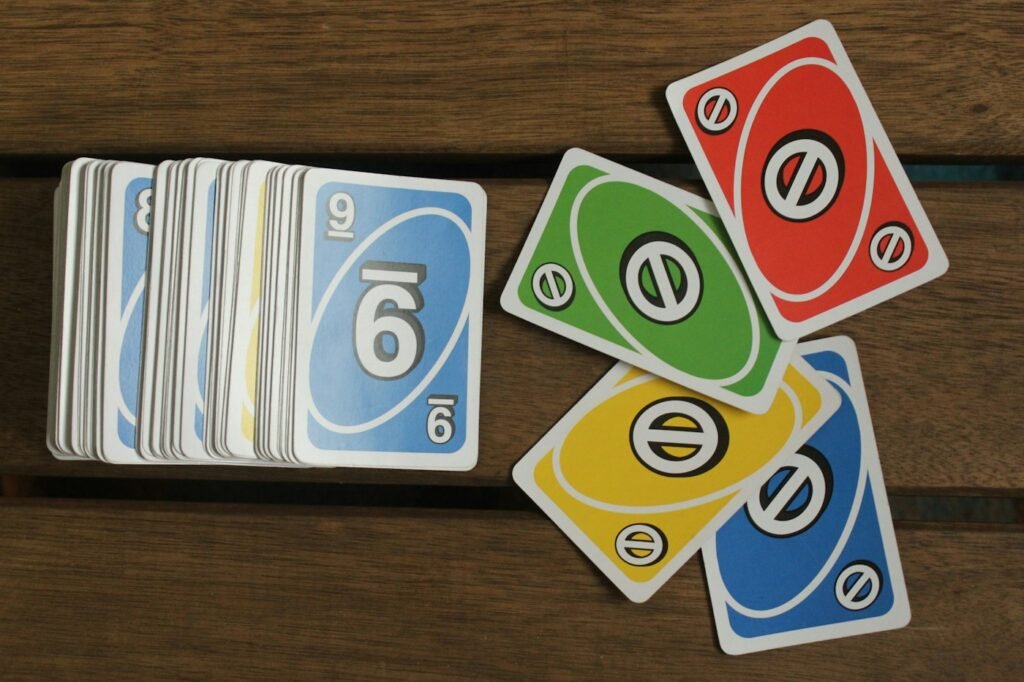 Pile of playing cards on a wooden table set up for a game of Golf