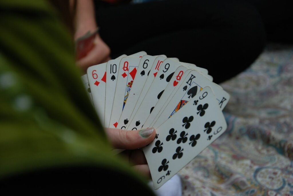 Player holding a fan of playing cards while deciding which card to swap
