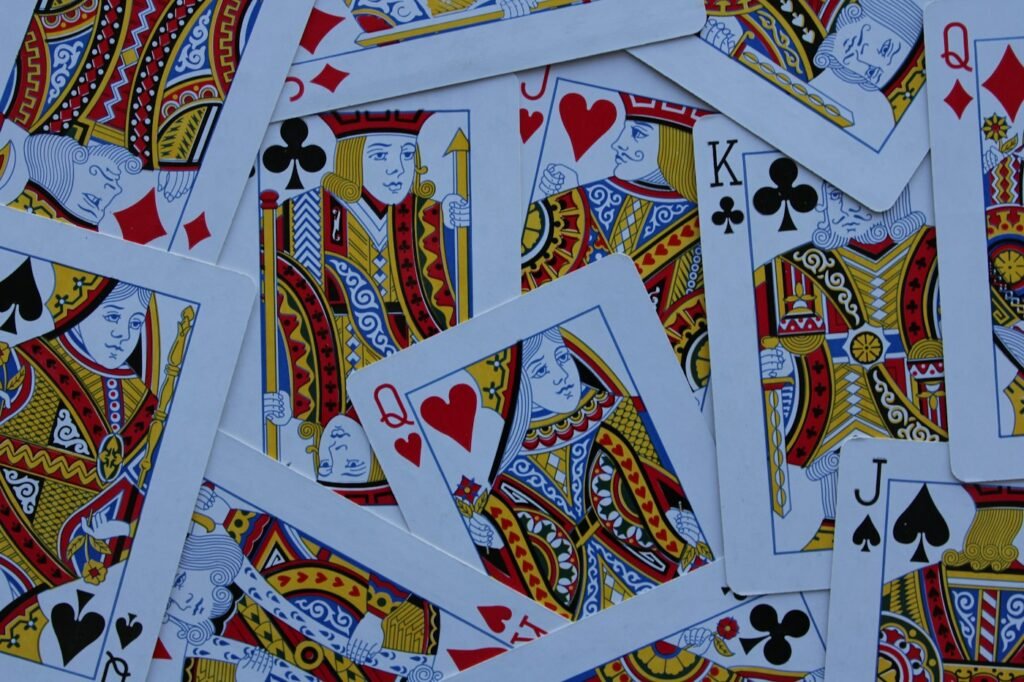 Scattered playing cards with kings, queens and jacks used in the Golf card game