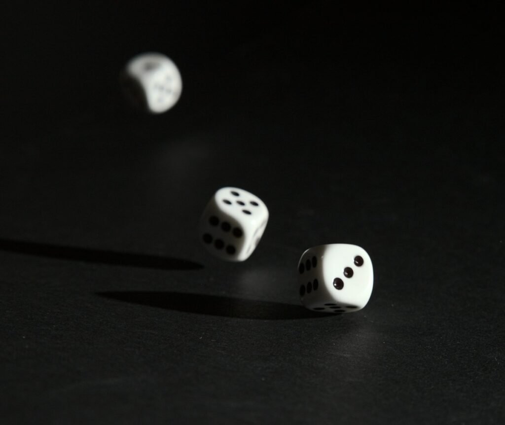 How to Play Left Right Center Dice Game: Rules, Setup and Fun Variations 2 White dice rolling on a dark surface during a dice game