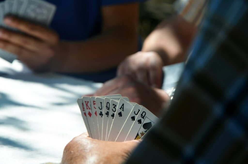 Group of people playing a card game together at a table