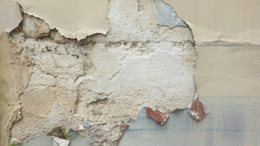 Damaged wall surface after old wallpaper has been removed