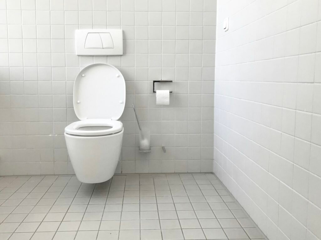 How to Unclog a Toilet Without a Plunger: 7 Easy Methods That Work 2 White toilet with tank in a clean bathroom