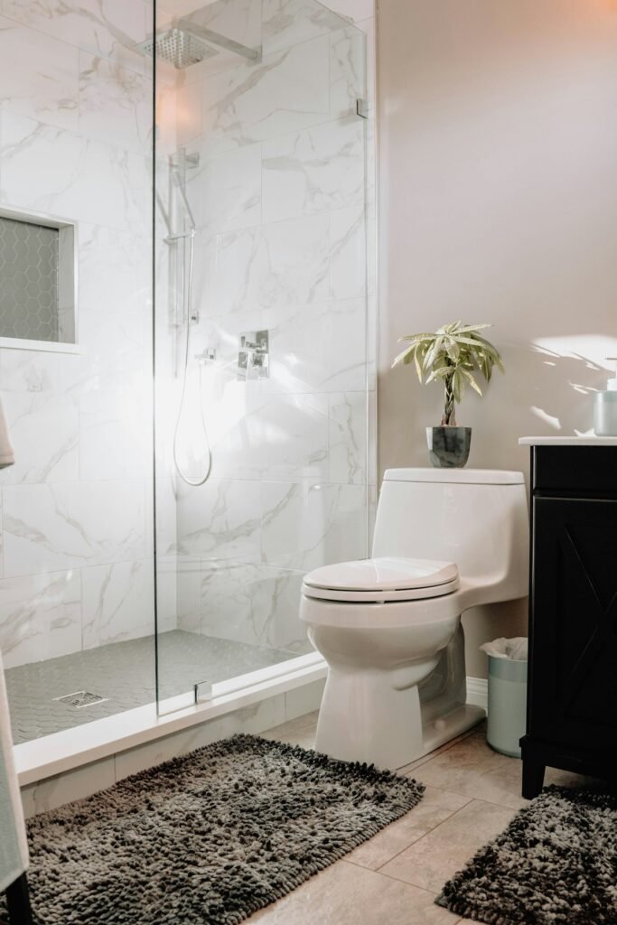 How to Unclog a Toilet Without a Plunger: 7 Easy Methods That Work 5 Modern bathroom with a toilet next to a glass shower