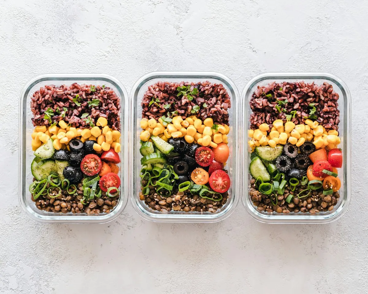 How to Save Money on Groceries: A Simple Weekly System That Works 5 Meal prep containers with home-cooked food to save money and reduce waste