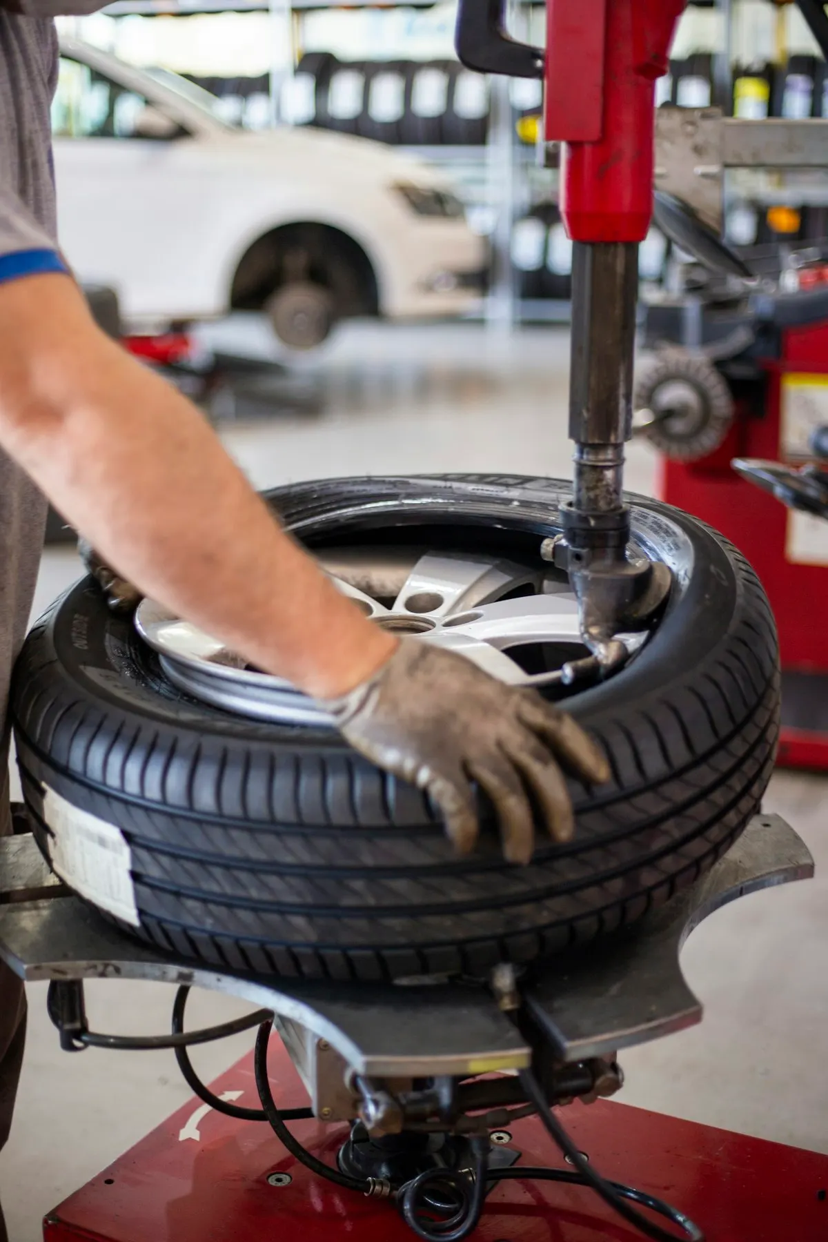 Mechanic inspecting a wheel and tire to find the cause of car shaking