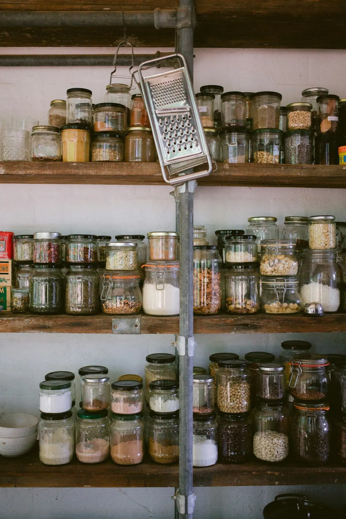 How to Save Money on Groceries: A Simple Weekly System That Works 4 Pantry jars filled with bulk dry staples like rice and oats