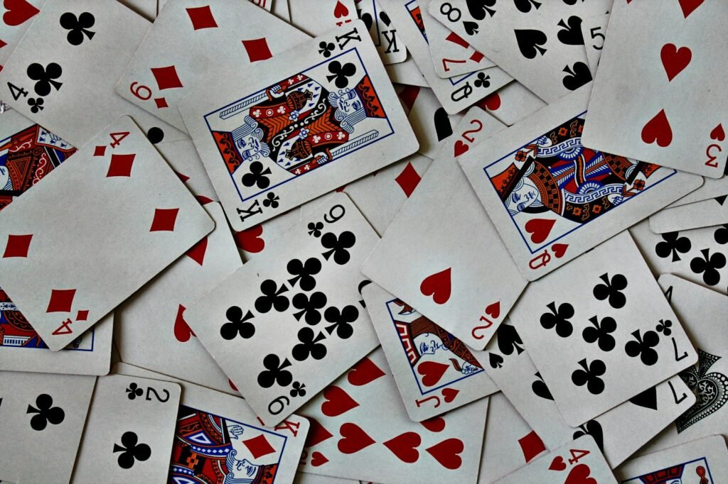 Pile of playing cards spread across a table after a round