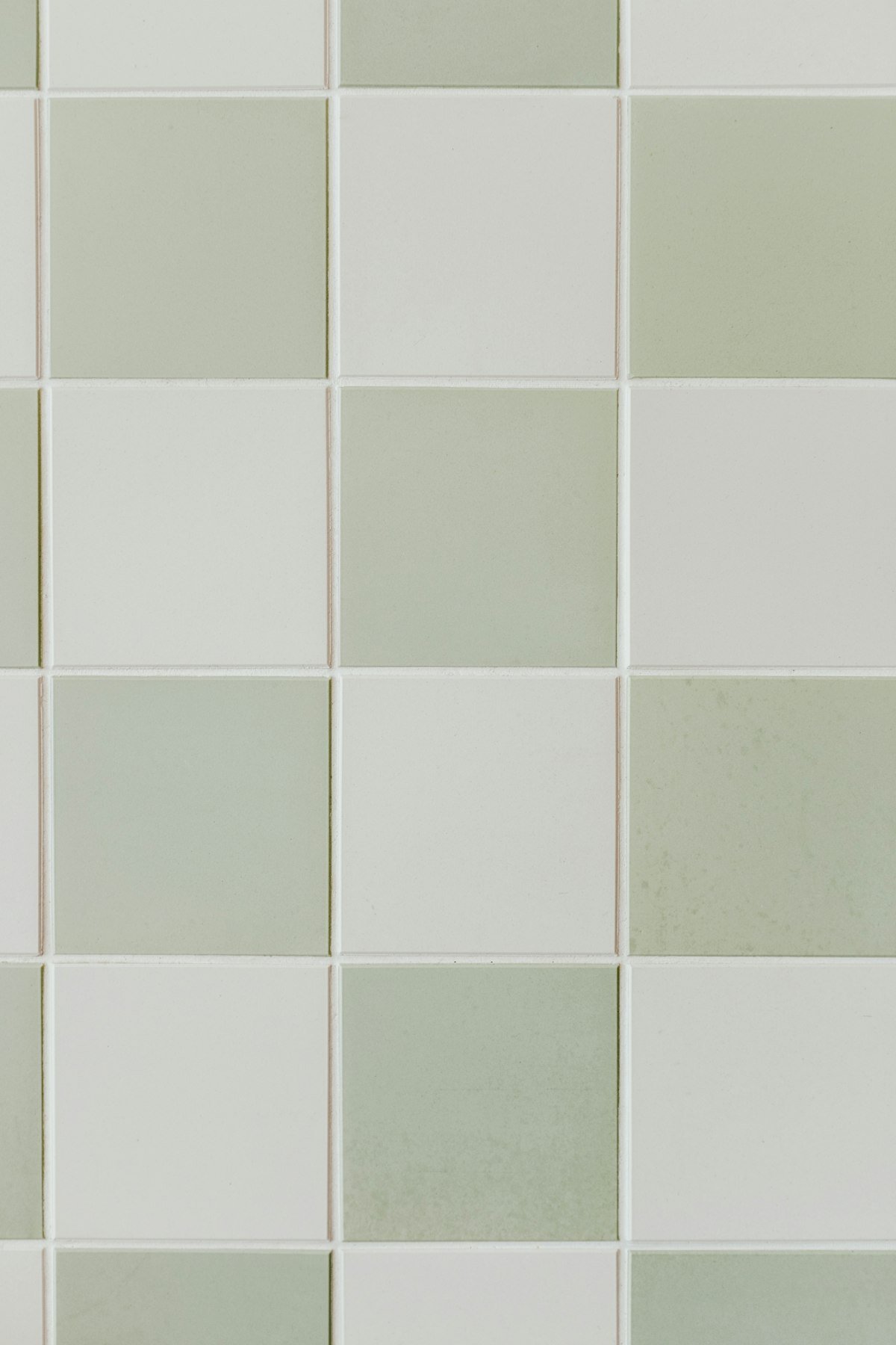 Clean sage green and off-white tiles with fresh grout lines