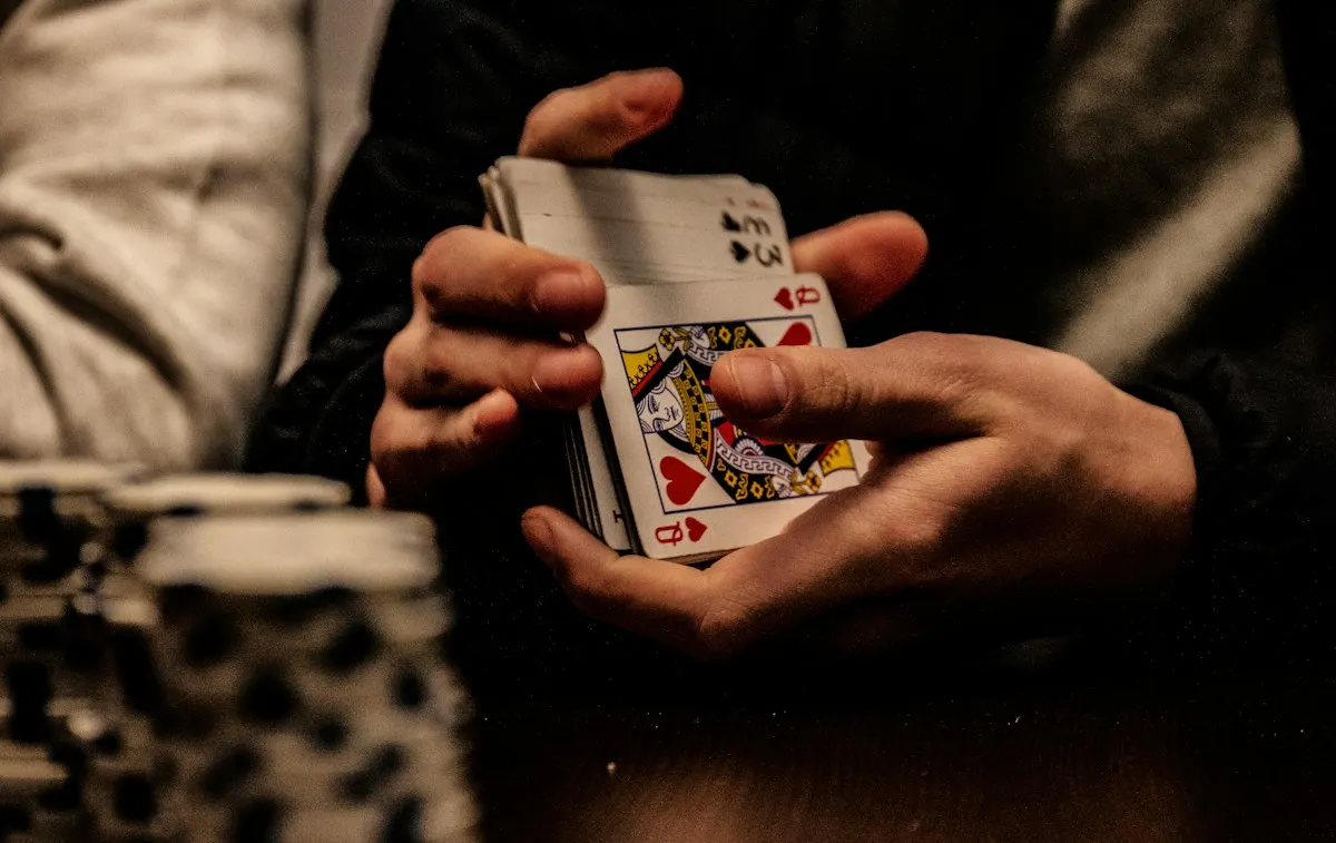 Player shuffling a deck of cards before dealing a Rummy 500 hand