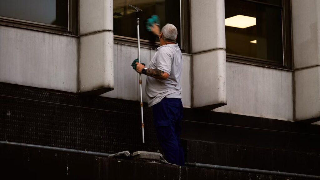 Person using a squeegee to leave glass streak-free