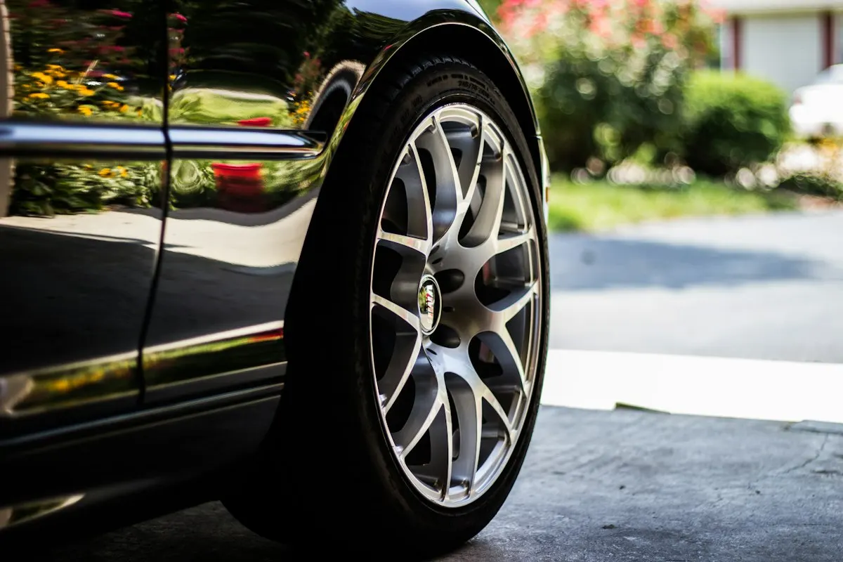 Close-up of a car wheel and tire, a common cause of shaking when accelerating