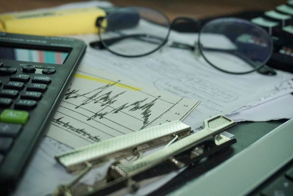 Desk with a calculator and papers for reviewing personal finances